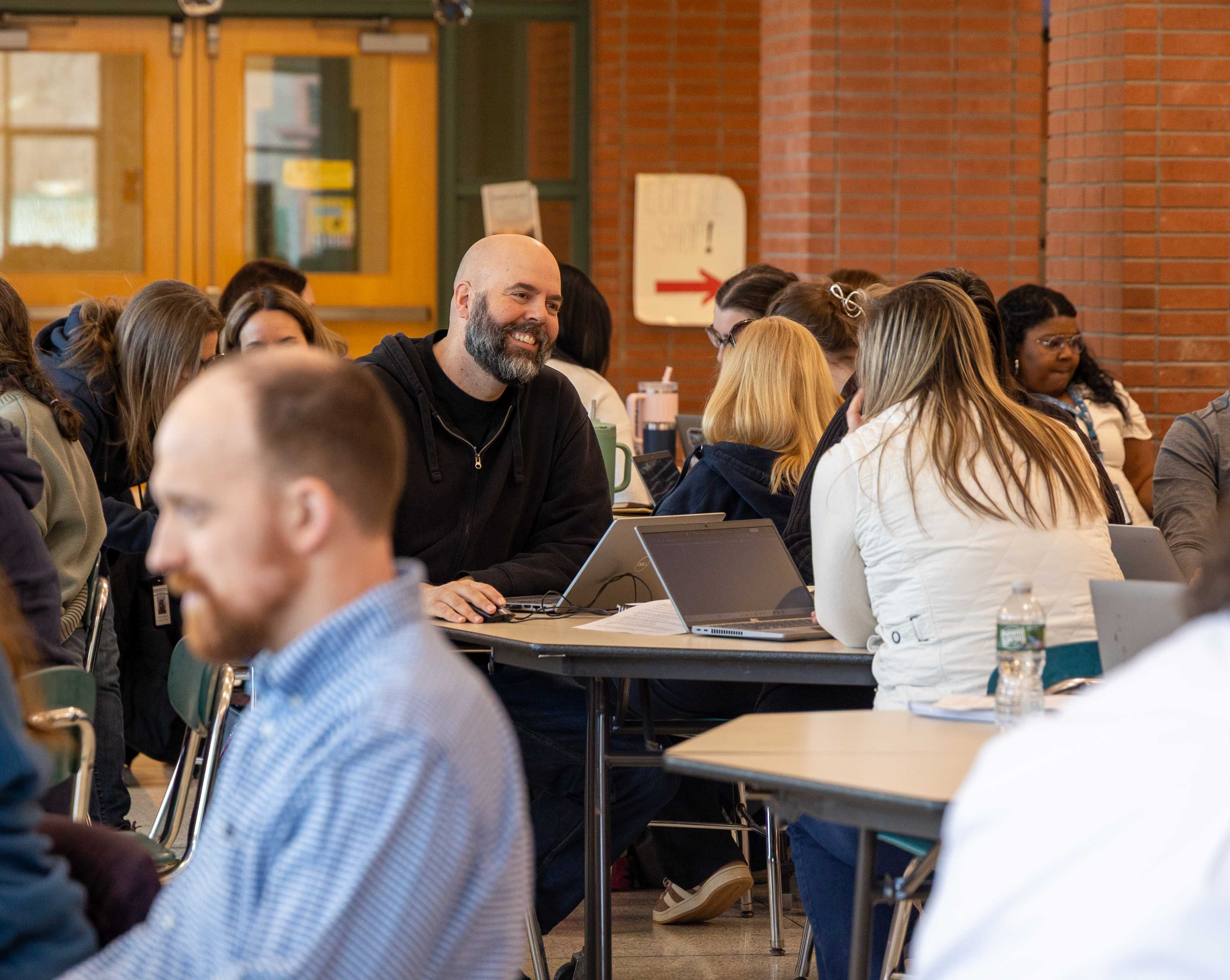 a faculty member smiles mid conversation